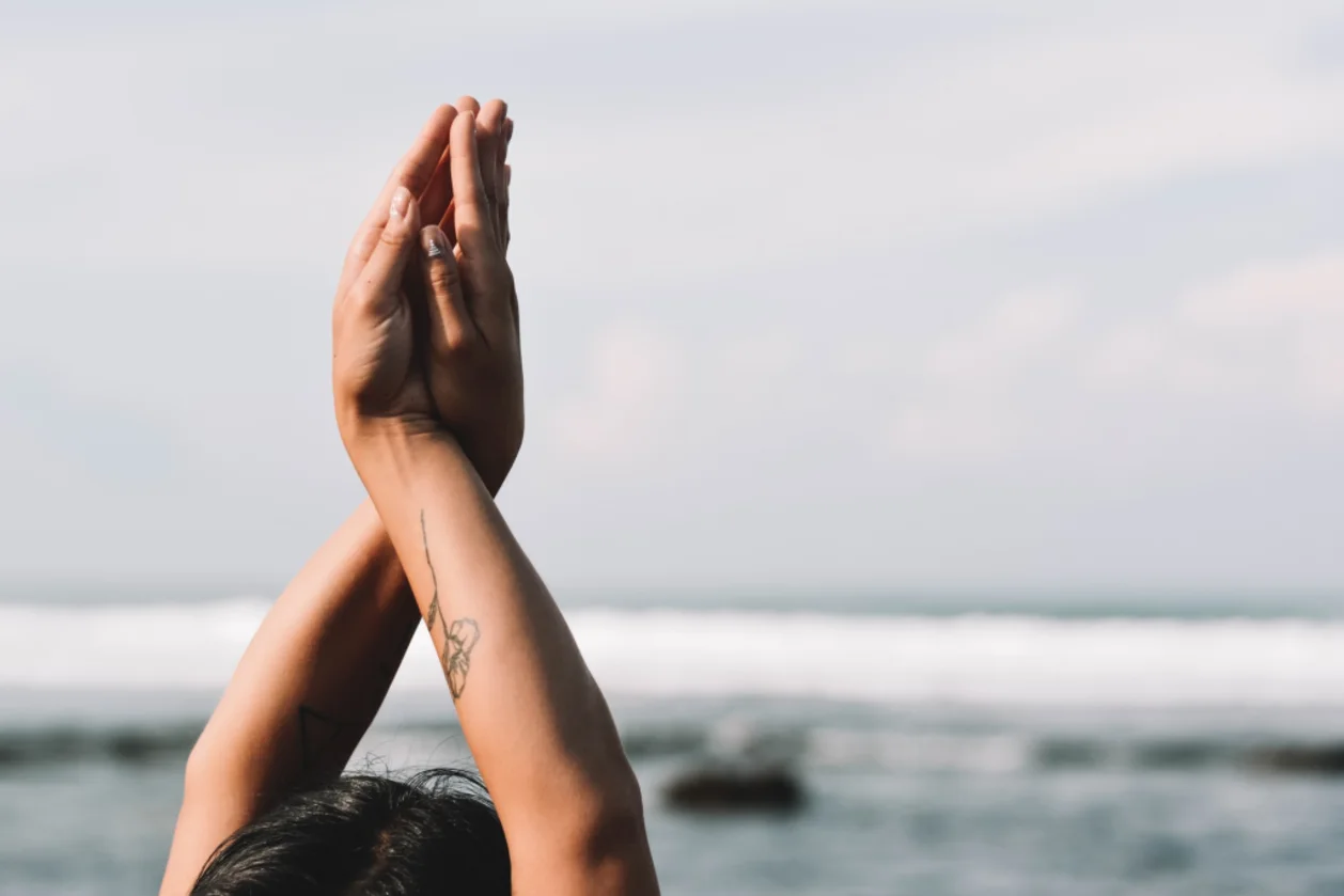 woman practicing mindfulness daily ritual on beach